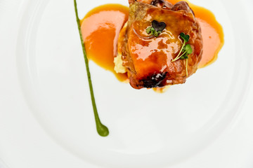 Modern cuisine, a plate with a meat medallion with sauce.