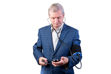 An elderly man in a suit measures pressure, by himself, with a hand tonometer. Isolated on a white background.