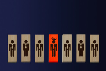 symbol of 7 men on wooden blocks, in the center a man with a crown, head concept, hierarchy in the work collective, copy space