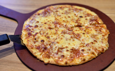 Hot pizza on wooden tray, Four cheese pizza