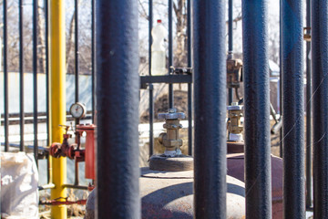 the working man has controlled gas cylinder propane closeup, the background is blurred with bokeh...