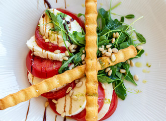 Portuguese salad snack mozarela with tomato and wafer rolls.