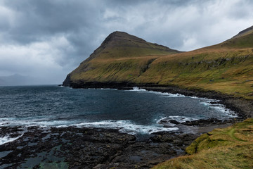 Dramatic landscape on Faroe Islands. Amazing seashore near village Gjógv (Gjov). Island of Eysturoy. North Atlantic ocean. 