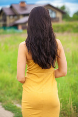 Naklejka na ściany i meble Female brunette hair, rear view, summer park