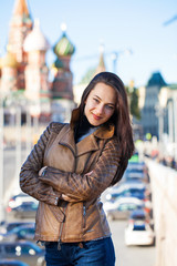 Fototapeta premium Young happy woman in brown leather jacket