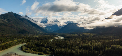 Aerial Panoramic View of Beautiful Canadian Mountain Landscape during a sunny and cloudy summer sunrise. Taken near Mt Robson, British Columbia, Canada.