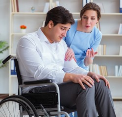 Obraz premium Disabled patient on wheelchair visiting doctor for regular check