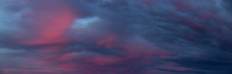 Dramatic Panoramic View of a cloudscape during a dark, rainy and colorful sunset. Taken in British Columbia, Canada.