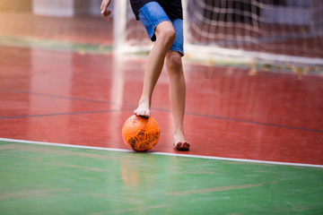 Futsal players barefoot. Futsal player  control and shoot ball to goal.   Indoor soccer sports...