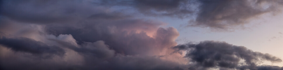 Obraz premium Dramatic Panoramic View of a cloudscape during a dark, rainy and colorful sunset. Taken in Alaska, USA.