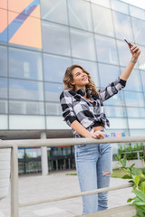 Stylish young woman taking selfie.