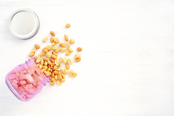 Peanuts spilling from jar