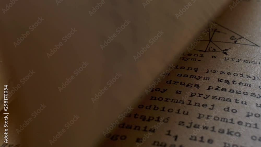 Aufkleber flicking through old typescript technical book pages close-up
