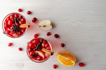 Orange and cranberry punch with orange slices and spices. Top view.