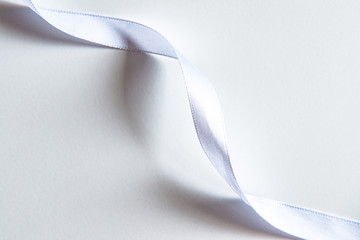 White ribbons on white background. Various curled ribbon