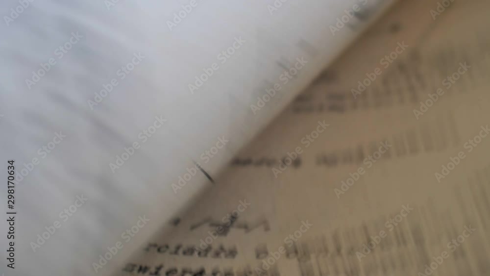 Aufkleber flicking through old typescript technical book pages close-up
