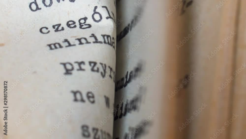 Aufkleber flicking through old typescript technical book pages close-up