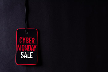 Cyber Monday Sale text on a red and black tag. Shopping concept.