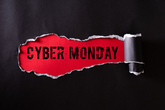 Top view of Black torn paper and the text Cyber Monday on a red background. Cyber Monday composition.