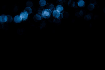 Abstract background blue bokeh with black background.