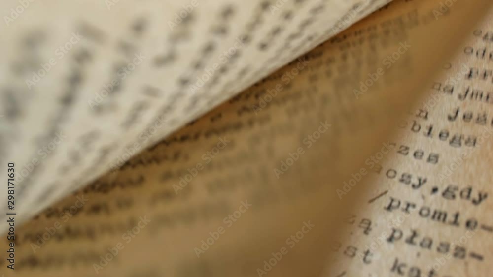 Poster flicking through old typescript technical book pages close-up