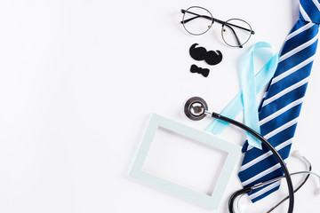 Blue ribbon with tie and stethoscope on white background representing an annual event during the...