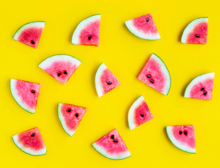 Slices of watermelon on yellow background.