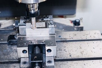 Metalworking CNC milling machine. Cutting aluminium parts in modern processing technology.