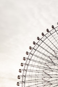 Close up of ferris wheel against cloudy sky