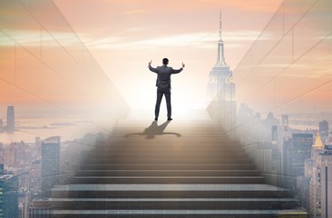 Businessman climbing up challenging career ladder in business co