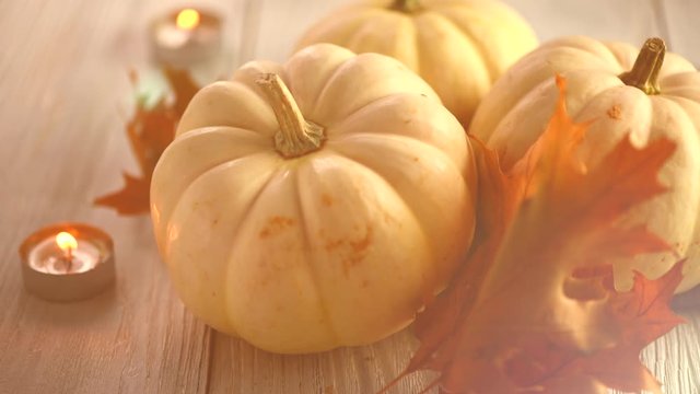 Thanksgiving Day Dinner, Served holiday table decorated with pumpkins, colorful autumn leaves and candles. Thanksgiving background, beautiful table setting. 4K UHD video