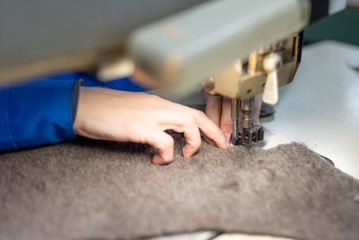 Sewing details of fur and leather. Shoe production.