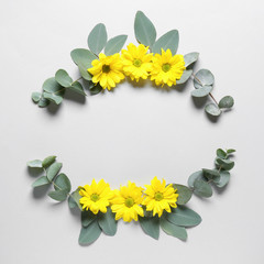 Composition with autumn flowers and eucalyptus on white background