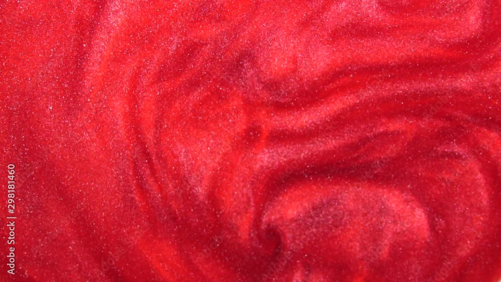 Poster red liquid with sparkles and pearly shine. abstract background. slow motion
