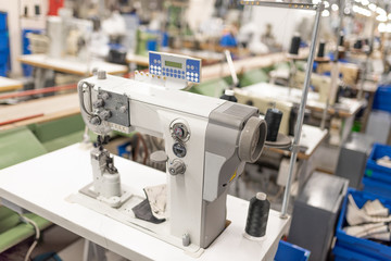 Fototapeta na wymiar Industrial sewing machine in the work shop. Shoe manufacturing.