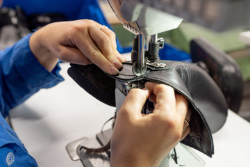 The process of sewing shoes on a sewing machine. Shoe production.