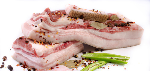 Pork belly fresh meat with spices preparation for salting on a white background