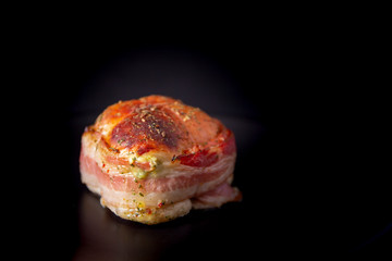 Chicken wrapped in bacon on the plate