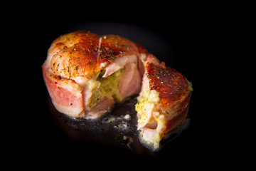 Chicken wrapped in bacon on the plate