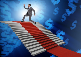 The young businessman climbing stairs and red carpet