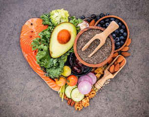Heart shape of ketogenic low carbs diet concept. Ingredients for healthy foods selection on dark...