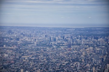 Fototapeta premium Aerial view of Bangkok Thailand and surrounding landscape, modern office buildings, condominium, living place in Bangkok city downtown in the most populated. Southeast Asia.