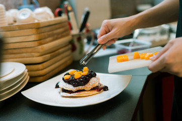 pancakes with blueberry and peach on white dish