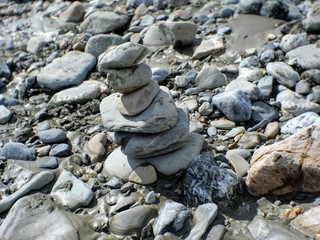 Fototapeta na wymiar Stack of rocks on the shore of a river