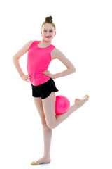 Girl gymnast performs exercises with the ball.