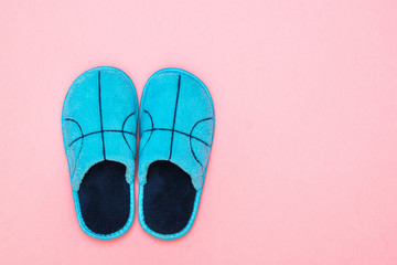 Blue Slippers with embroidery on a pink background. The view from the top. Flat lay. Color trend.