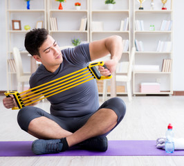 Young man exercising at home in sports and healthy lifestyle con