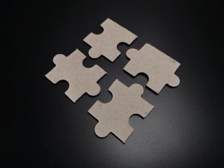 Black paper jigsaw puzzle black background