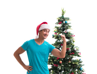 Young man decorating christmas tree isolated on white