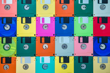 Background from multi-colored diskettes. Colored floppy disks.